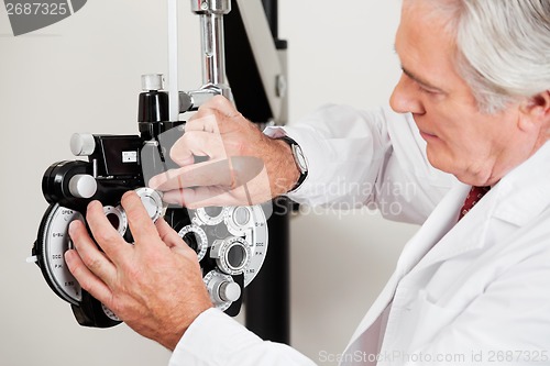 Image of Optometrist Setting Phoropter For Eye Test
