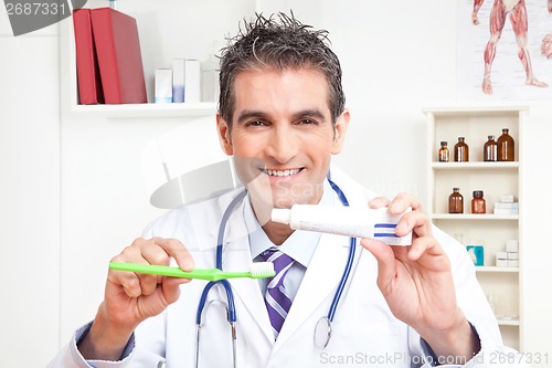 Image of Doctor Holding  Tooth Brush and Toothpaste