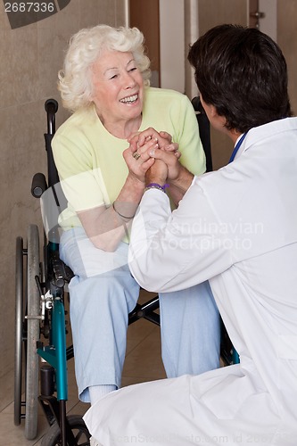 Image of Doctor with Patient on Wheel Chair