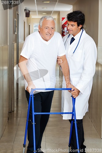 Image of Doctor Assisting Old Man On a Walker