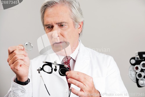 Image of Optometrist Checking the Lens Of Trial Frame