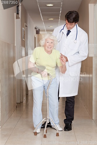 Image of Doctor helping Patient use Walking Stick