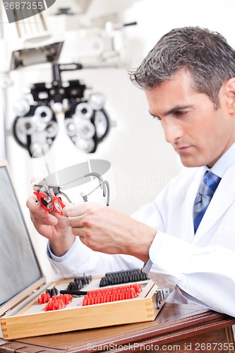 Image of Optometrist Holding Measuring Eye Glasses