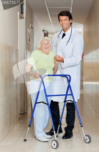 Image of Doctor Assisting An Old Woman With Her Walker