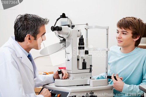 Image of Boy Consulting Doctor After Visual Field Test