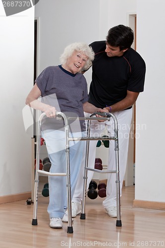 Image of Therapist helping Patient use Walker