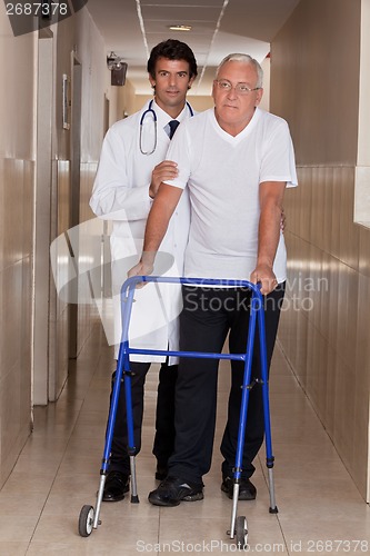 Image of Doctor helping Patient use Walker