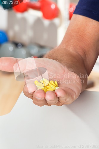 Image of Senior Man's Hand Holding Tablets