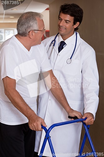 Image of Doctor helping Patient use Walker