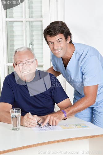 Image of Mature Man playing Sudoku Puzzle