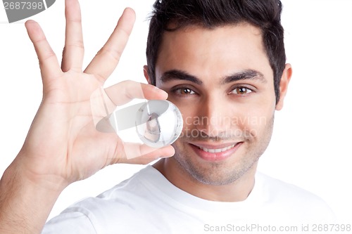 Image of Young Man Holding Crystal Ball