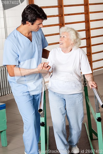 Image of Woman On Walking Track Looking At Physical Therapist