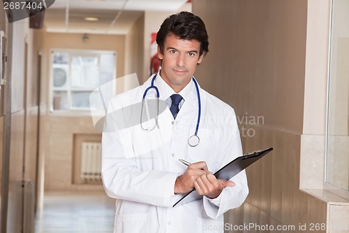 Image of Male Doctor Standing with Folder