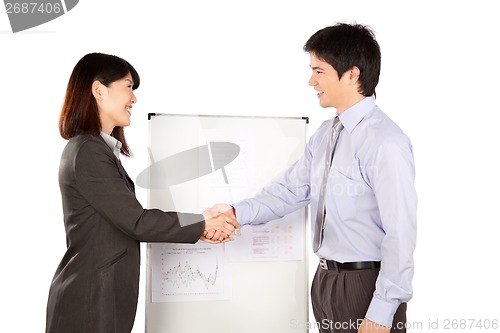 Image of Businesswoman and Businessman Shaking Hand