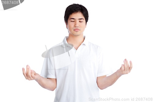 Image of Young Asian Man Meditating