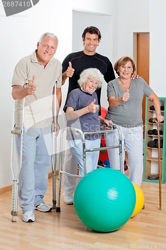 Image of Disabled Senior People With Trainer Showing Thumbs Up Sign