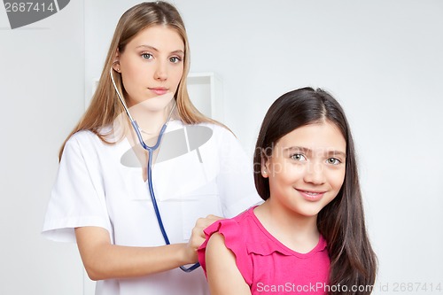 Image of Doctor Examining Child in Clinic