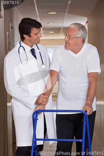 Image of Doctor helping Patient use Walker