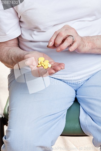 Image of Sick Woman taking her Pills