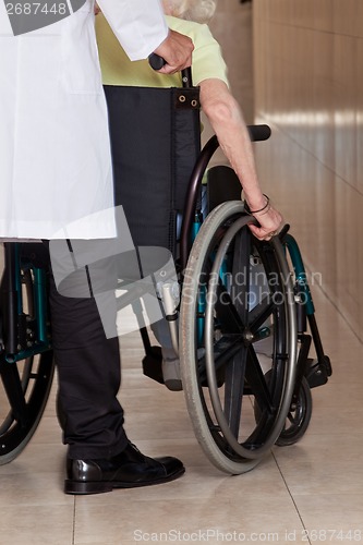 Image of Doctor with Patient on Wheel Chair