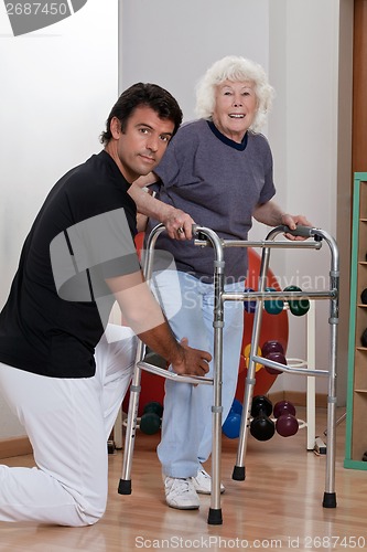 Image of Therapist helping Patient use Walker