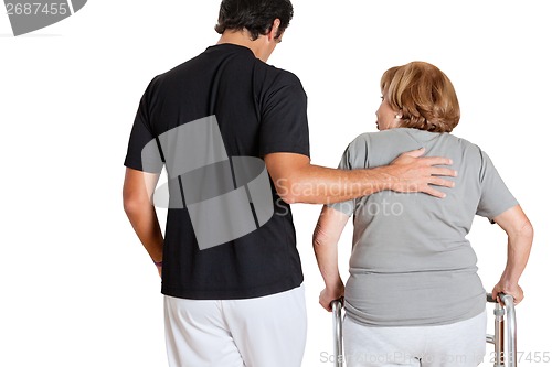 Image of Trainer Assisting Senior Woman With Her Walker