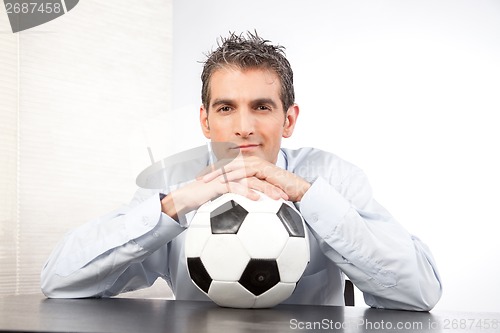 Image of Businessman With Football At Work