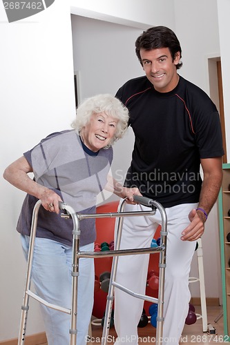 Image of Therapist helping Patient use Walker