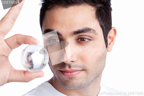 Image of Young Man Holding Crystal Ball