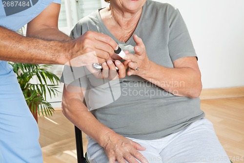 Image of Male Nurse Checking Sugar Level Of Patient