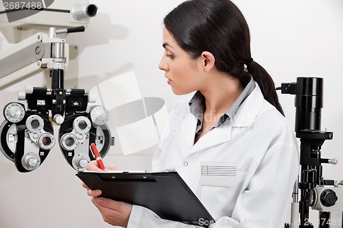 Image of Eye Doctor Writing About Phoropter