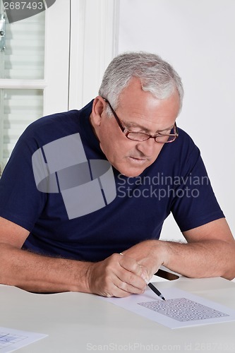 Image of Mature Man playing Scrabble Game