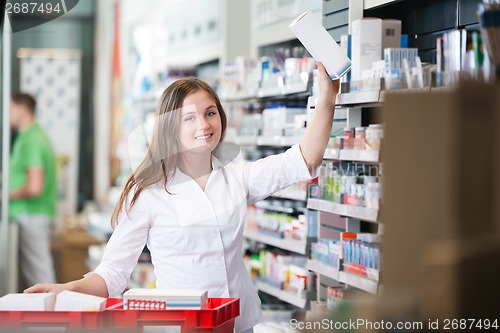 Image of Female Keeping a Box on Shelf