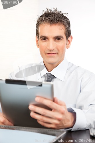 Image of Businessman Holding Digital Tablet