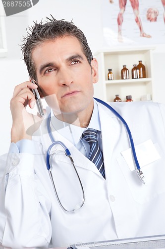 Image of Male Doctor Using Mobile Phone