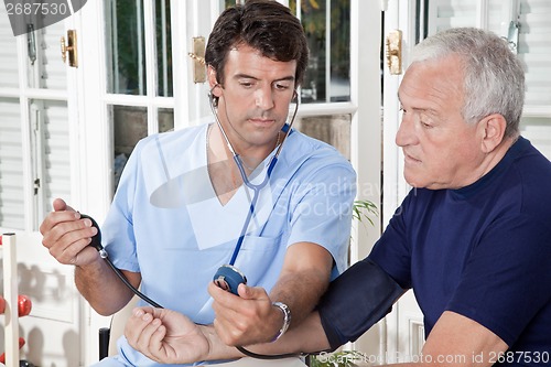 Image of Doctor taking the Blood Pressure
