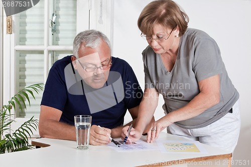 Image of Mature Couple playing Scrabble Game