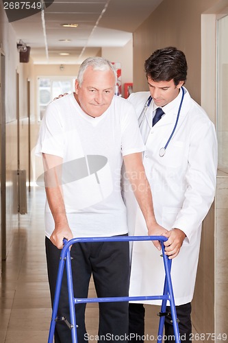 Image of Doctor helping Patient use Walker