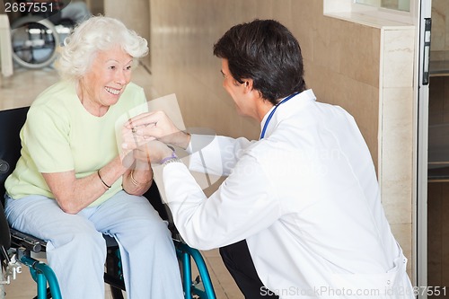 Image of Doctor Comforting Happy Senior Woman