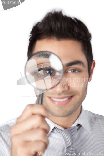 Image of Businessman Holding Magnifying Glass