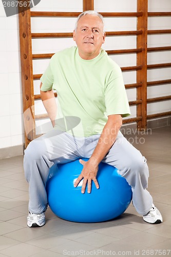 Image of Senior Man Sitting On Fitness Ball