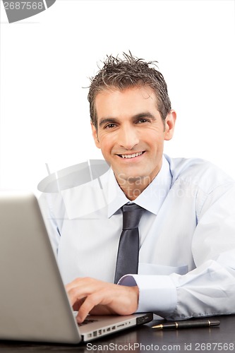 Image of Businessman Using Laptop at Work