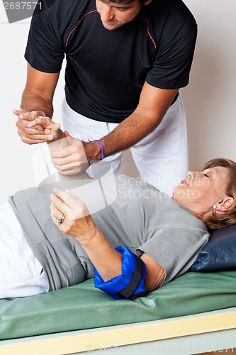 Image of Therapist Examining Woman's Hand