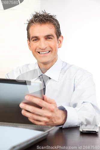 Image of Businessman Holding Digital Tablet