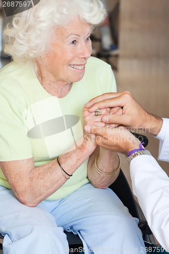 Image of Doctor Comforting Senior Woman