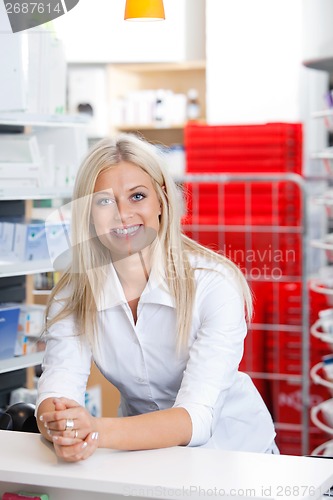 Image of Smiling Female Chemist at Counter