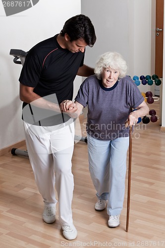 Image of Therapist helping Patient To Walk