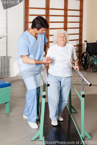 Image of Therapist Assisting Tired Senior Woman On Walking Track