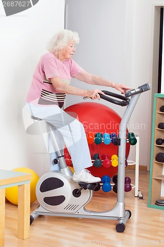 Image of Senior Woman Exercising On Bike