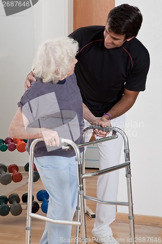 Image of Therapist helping Patient use Walker